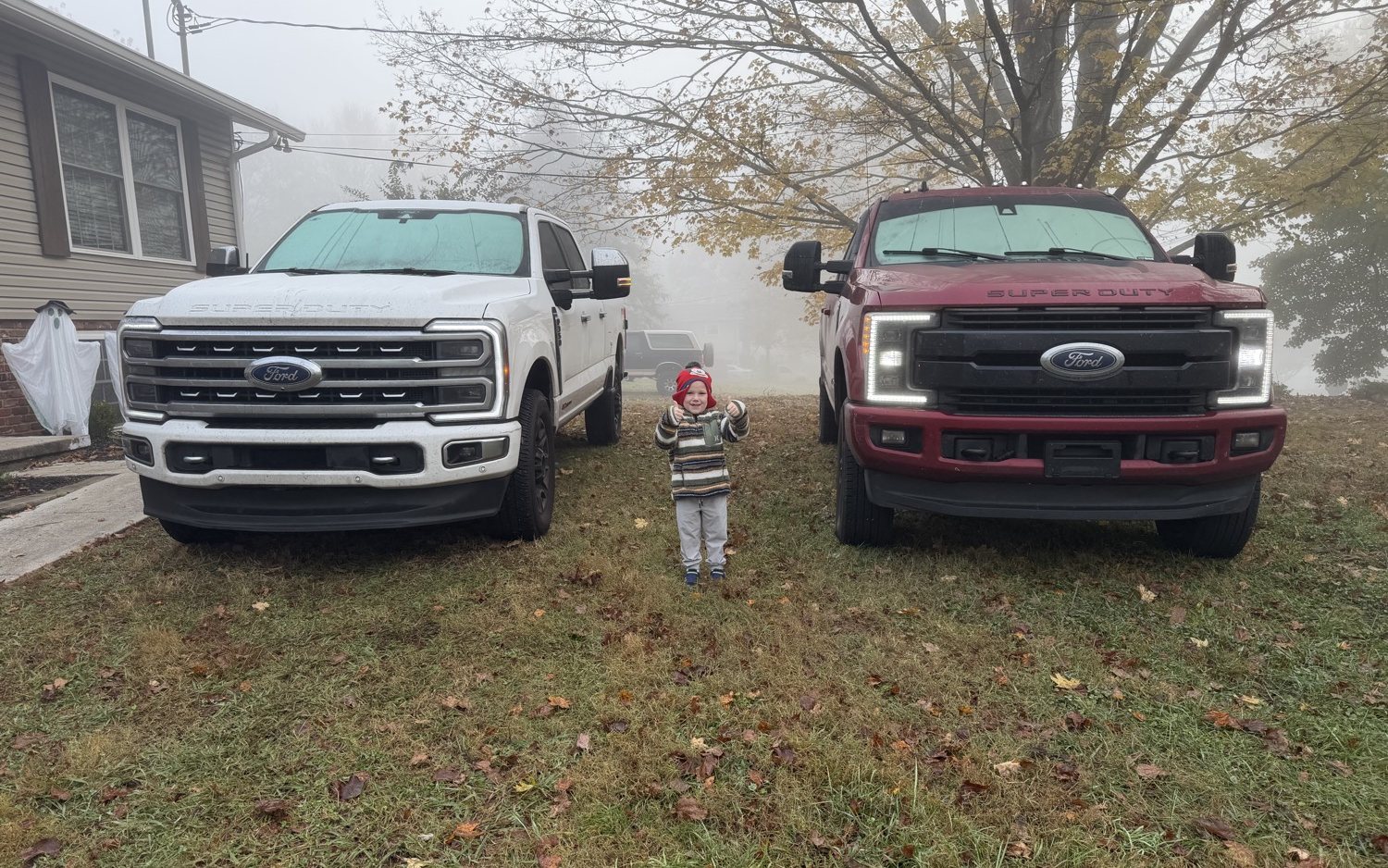 Brady’s two Super Duties and his son at home in Knoxville